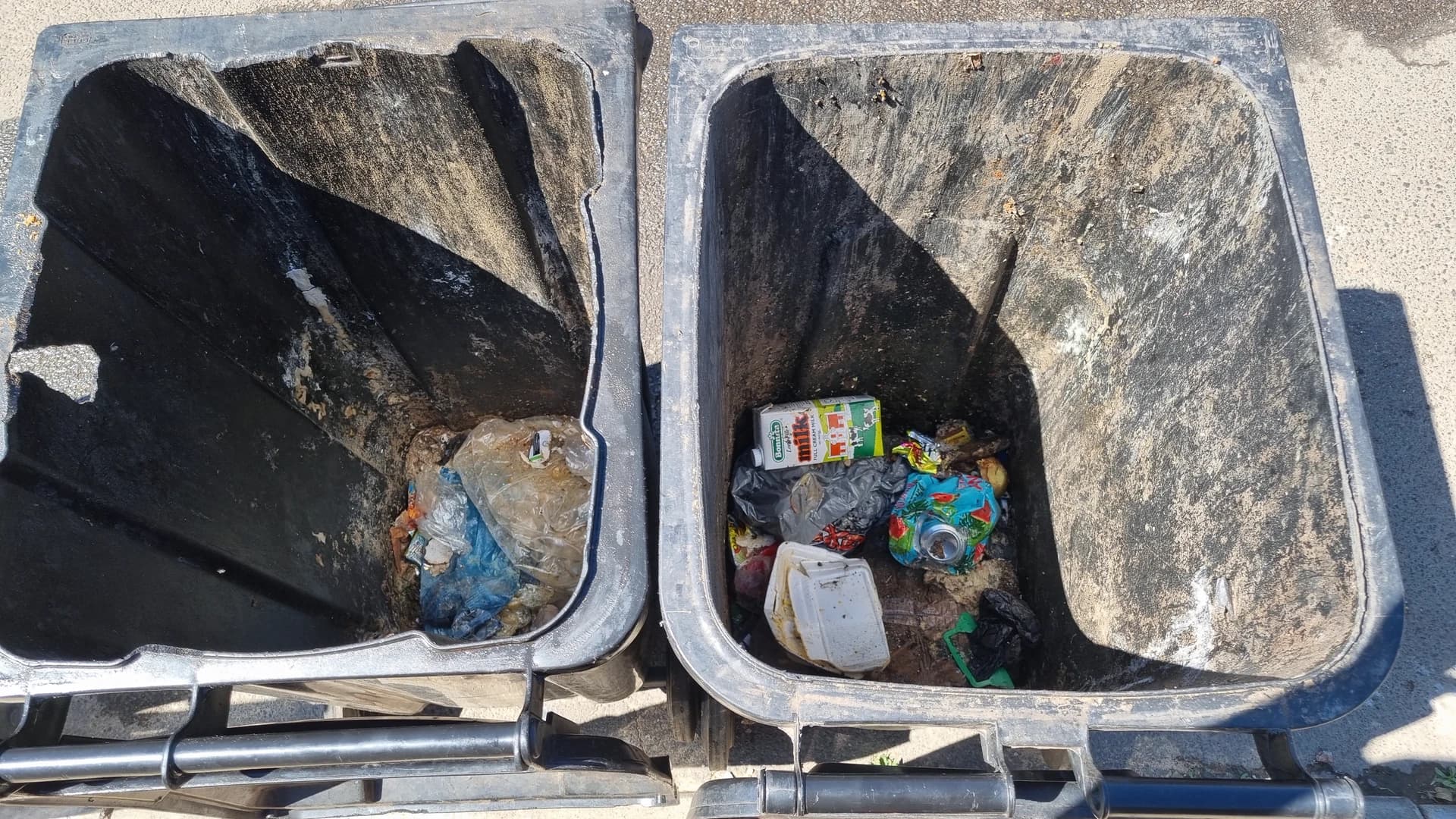 Two dirty wheelie bin interiors before MaT cleaning