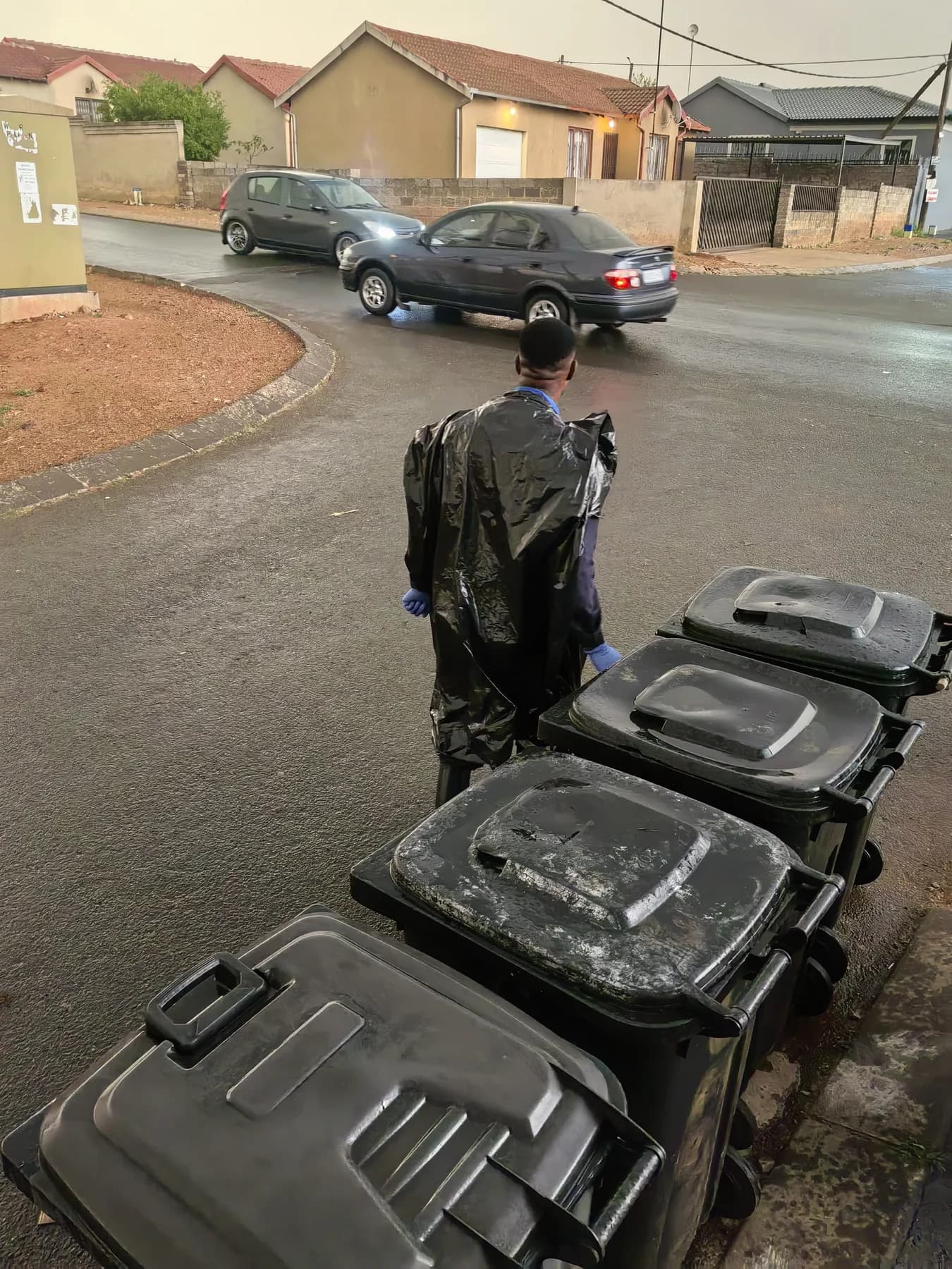 MaT team member working beside several wheelie bins in a Gauteng neighbourhood